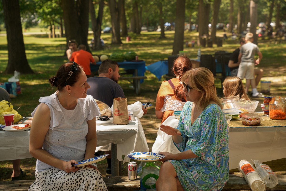 Church families sharing a meal at the summer picnic