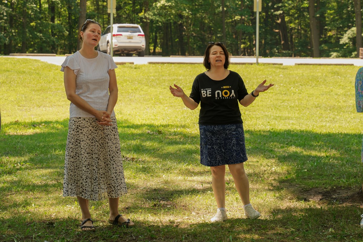 Two women talking together outdoors at a church gathering