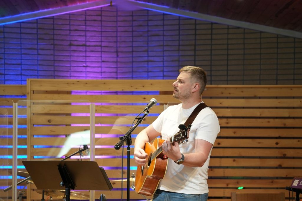 A guitarist leading worship at New Hope Slavic Church